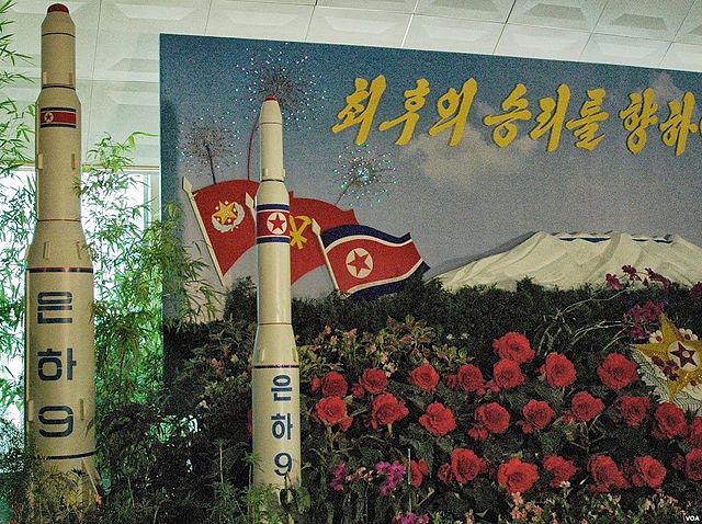 Photo: Model of a Unha-9 rocket on display at a floral exhibition in Pyongyang, 30 August 2013 | Credit: Steve Herman – VOA - Wikimedia Commons