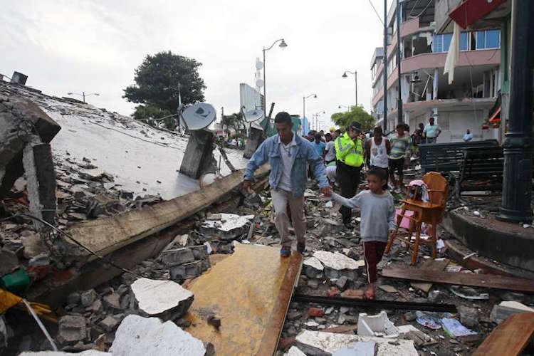 Photo: People walk among the debris of a collapsed building in the town of Pedernales, Ecuador, following a 7.8 magnitude earthquake. Credit: UNHCR