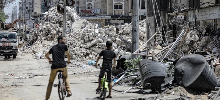 two_cyclists_in_gaza_ruins.jpg